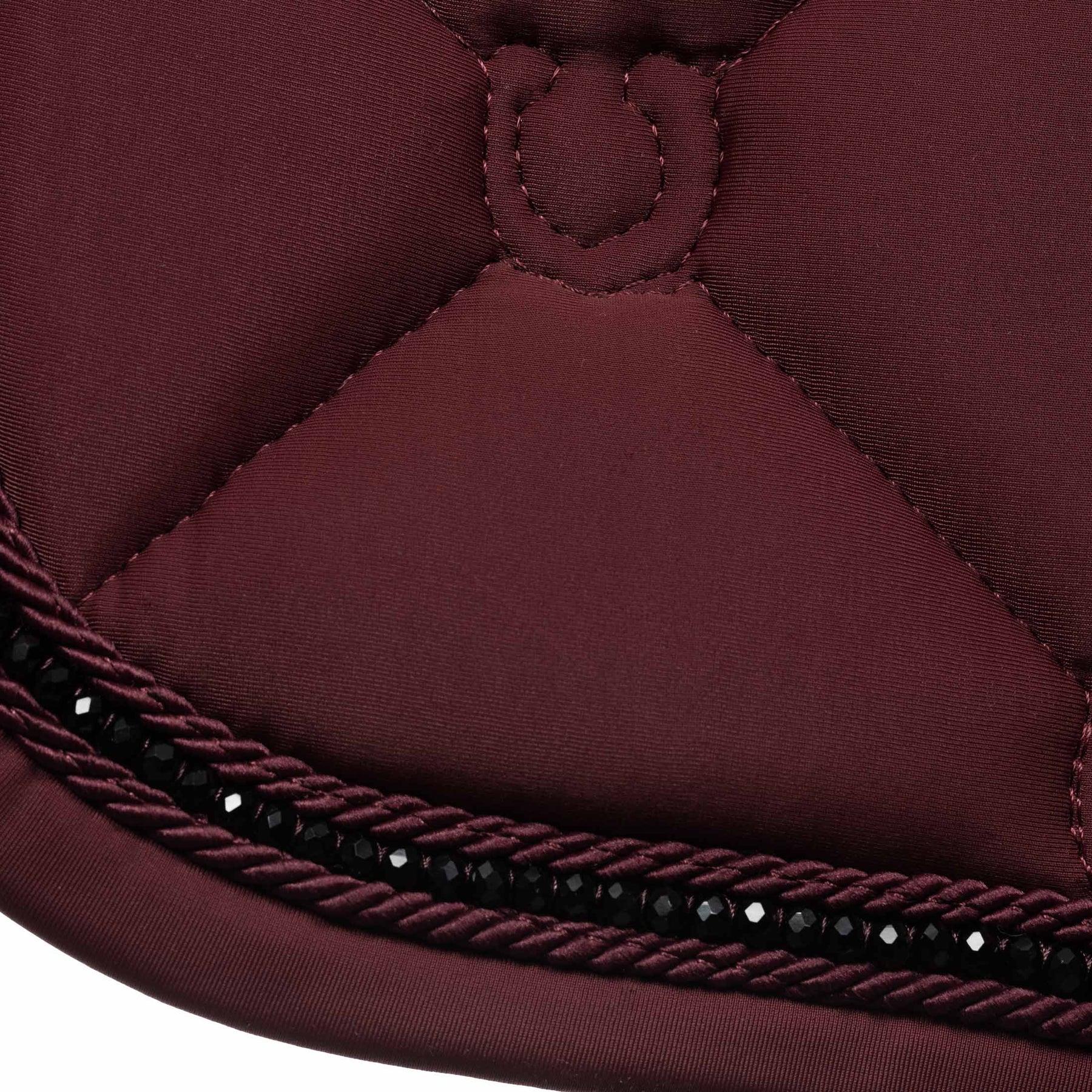 Close-up view of the black rhinestones on the Burgundy Equinavia Bergen Crystal Dressage Saddle Pad