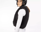 Side view of a female model wearing an inflated Freejump Airbag on a white background