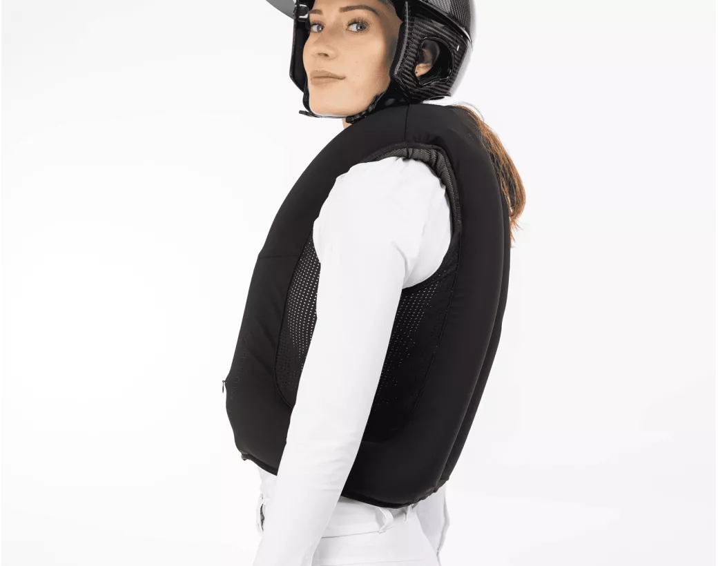 Side view of a female model wearing an inflated Freejump Airbag on a white background