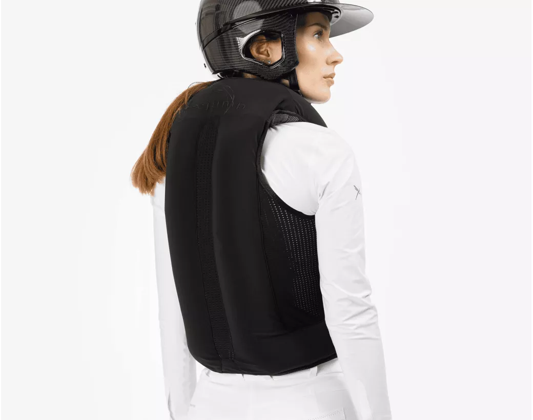 Back view of a female model wearing an inflated Freejump Airbag on a white background