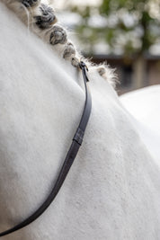 View of the Brown/Brass LeMieux Rubber Reins against a gray horse's neck