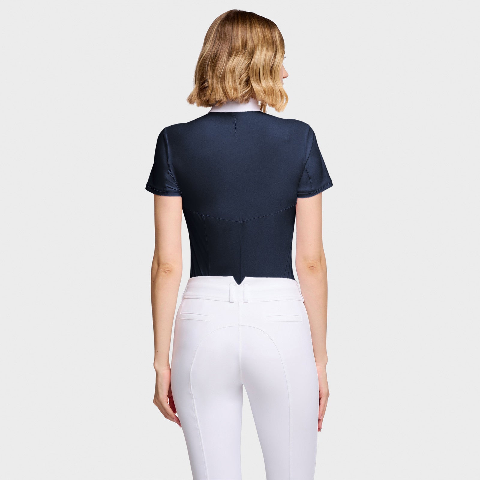 Back view of a female model wearing the Navy Samshield Gretta Short Sleeve Show Shirt on a plain background