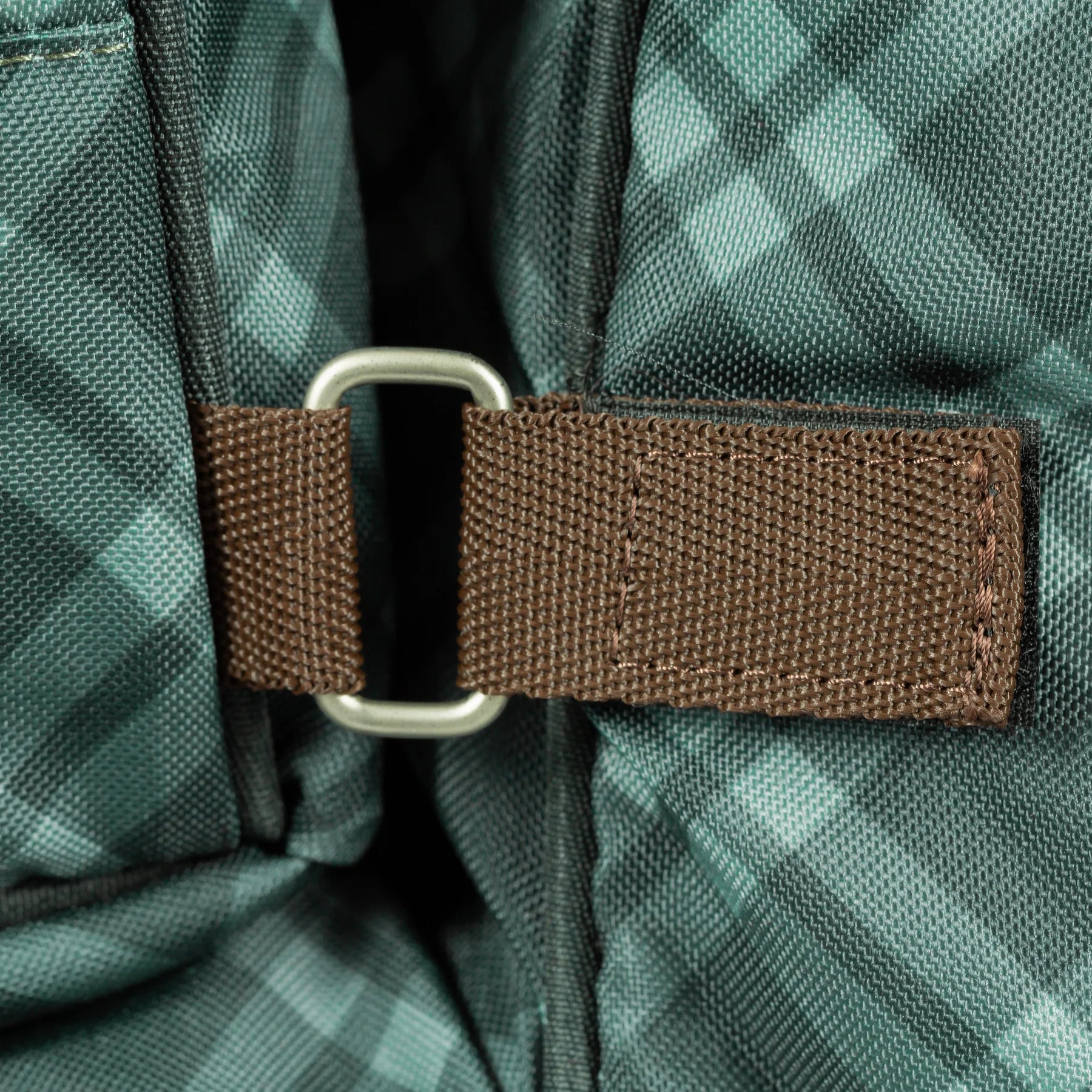 Close-up detail view of the Thyme/Lily Pad Equinavia Boot and Detachable Helmet Bag on a plain background showing the velcro connector that lets you attach or detach the helmet bag