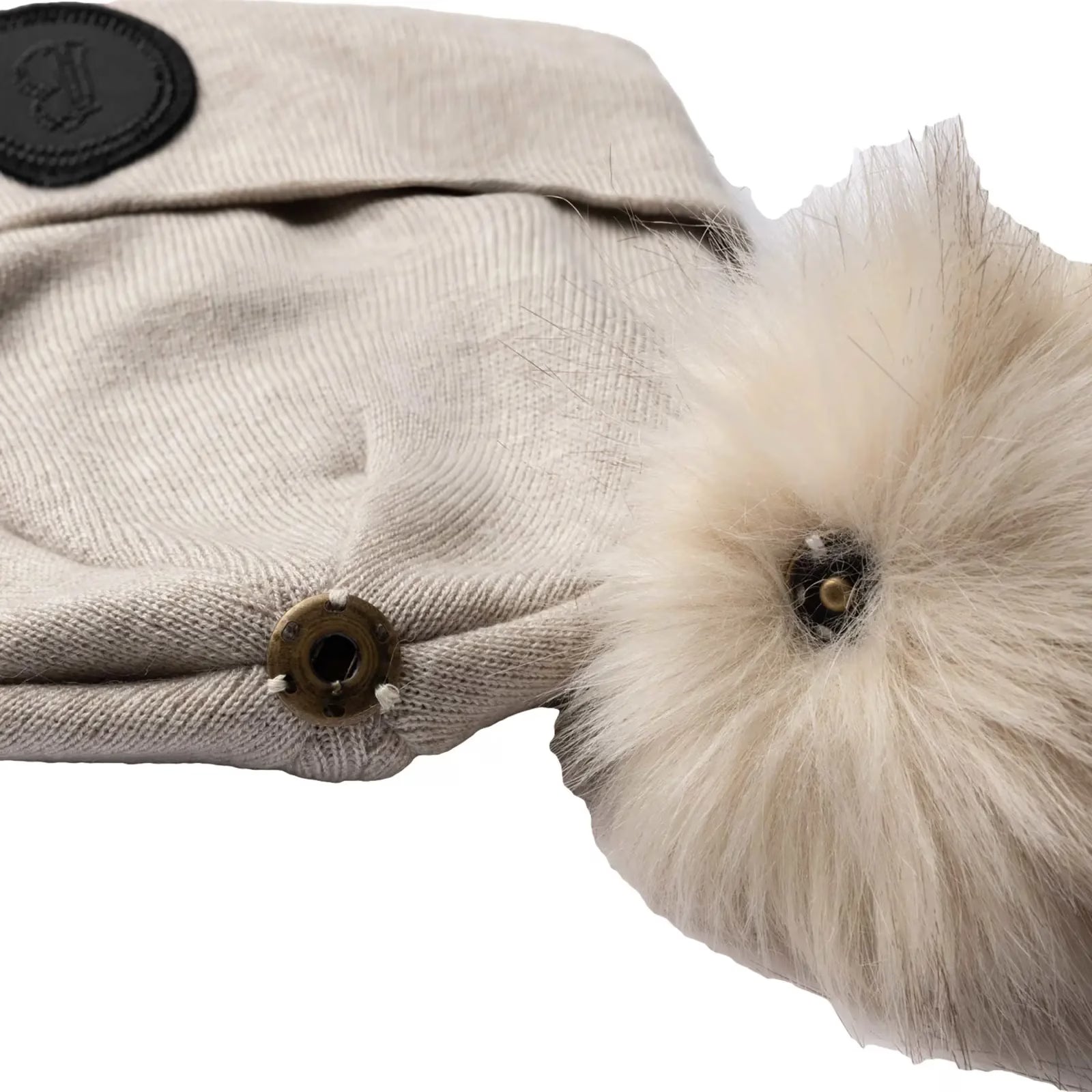 Close-up view of the pom snap on the beige B Vertigo Sydney Knitted Hat on a white background