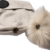 Close-up view of the pom snap on the beige B Vertigo Sydney Knitted Hat on a white background