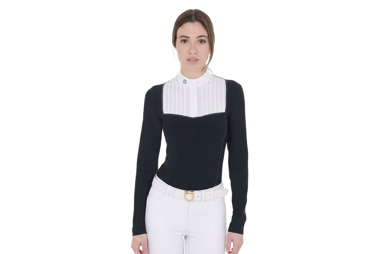 Black long sleeve show shirt with white pleated bib and rhinstone trim detailing shown on model in front of plain white background