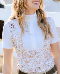 Woman wearing a white blouse with floral pattern outdoors