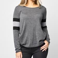 Grey knit long sleeve sweater with stripes shown on model