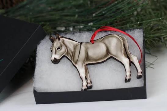 Flat grey donkey ornament with red ribbon shown in gift box