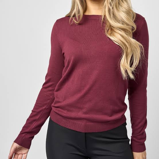 Knit long sleeve burgundy sweater shown on model on plain white background