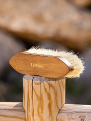 View of the LeMieux Artisan Deep Clean Dandy Brush on a wooden fence post