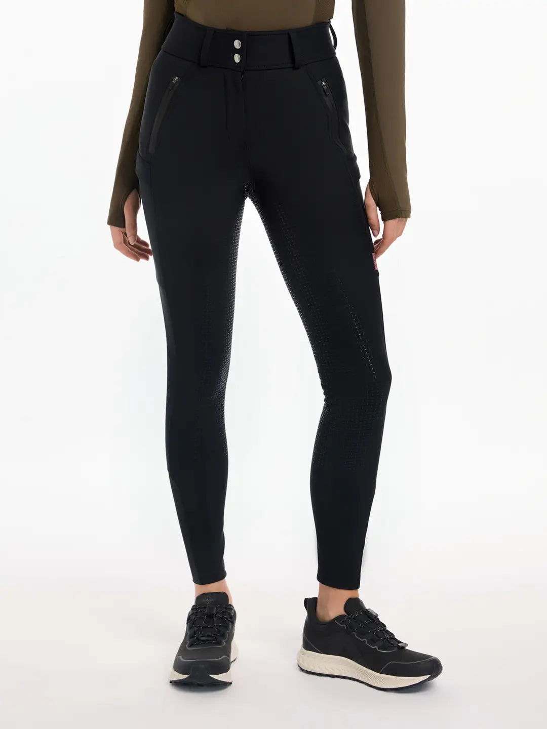 Front view of a model wearing the black DryTex Waterproof Full Seat Breeches on a white background