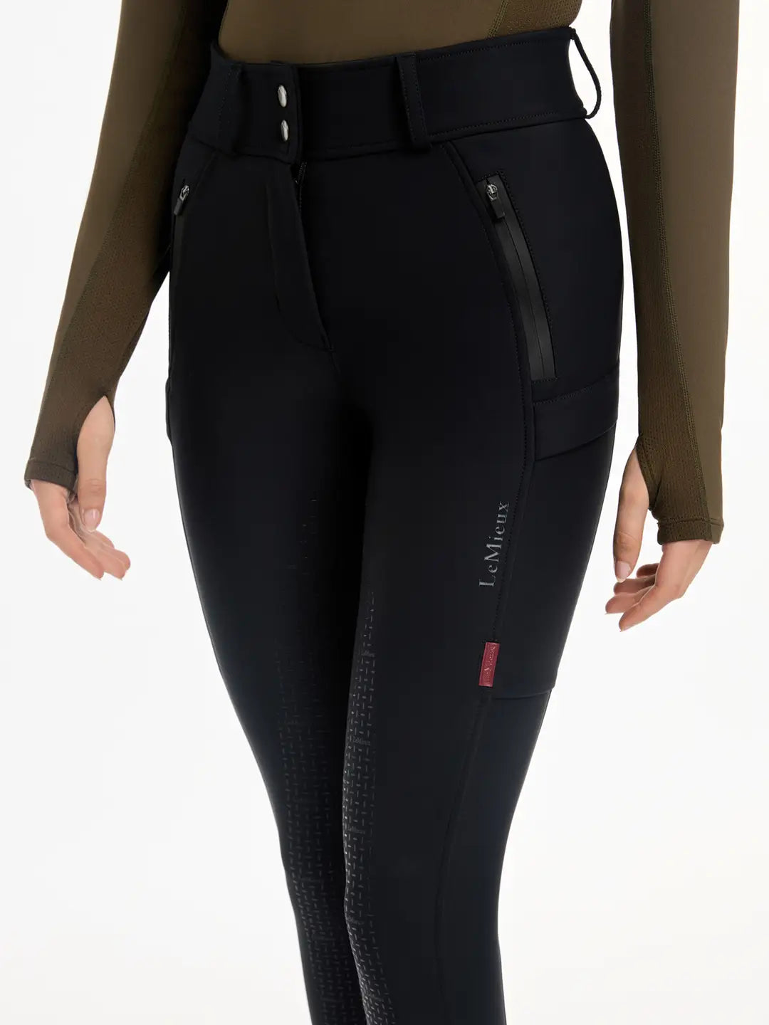 Close-up front view of a model wearing the black DryTex Waterproof Full Seat Breeches on a white background