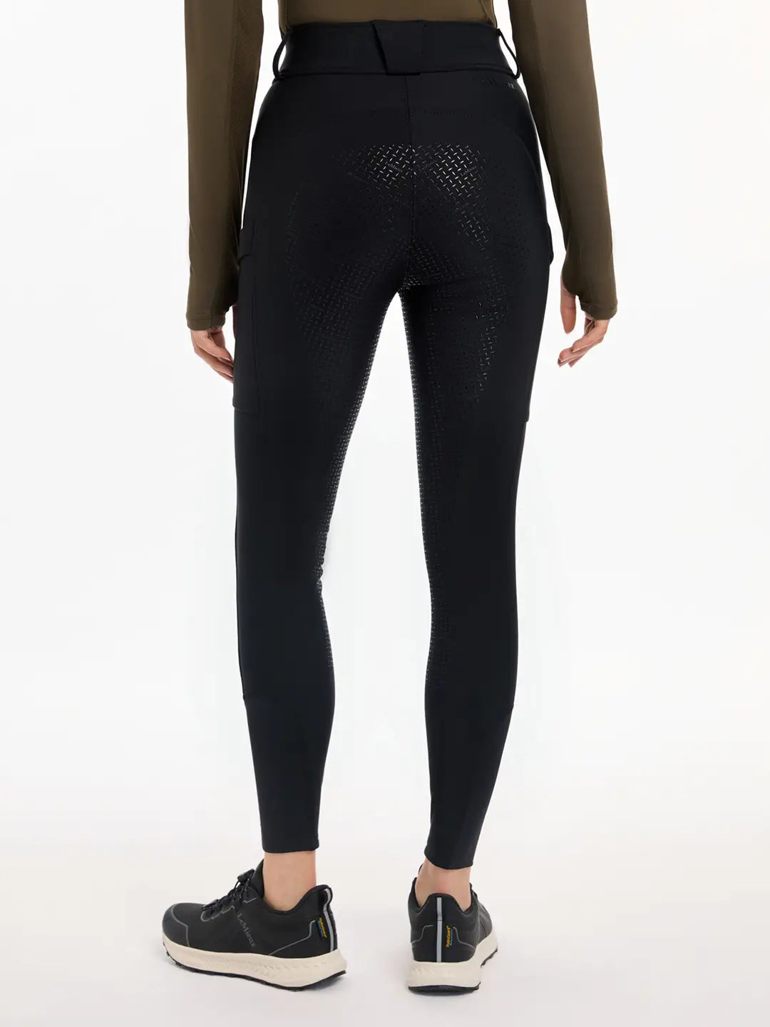 Back view of a model wearing the black DryTex Waterproof Full Seat Breeches on a white background