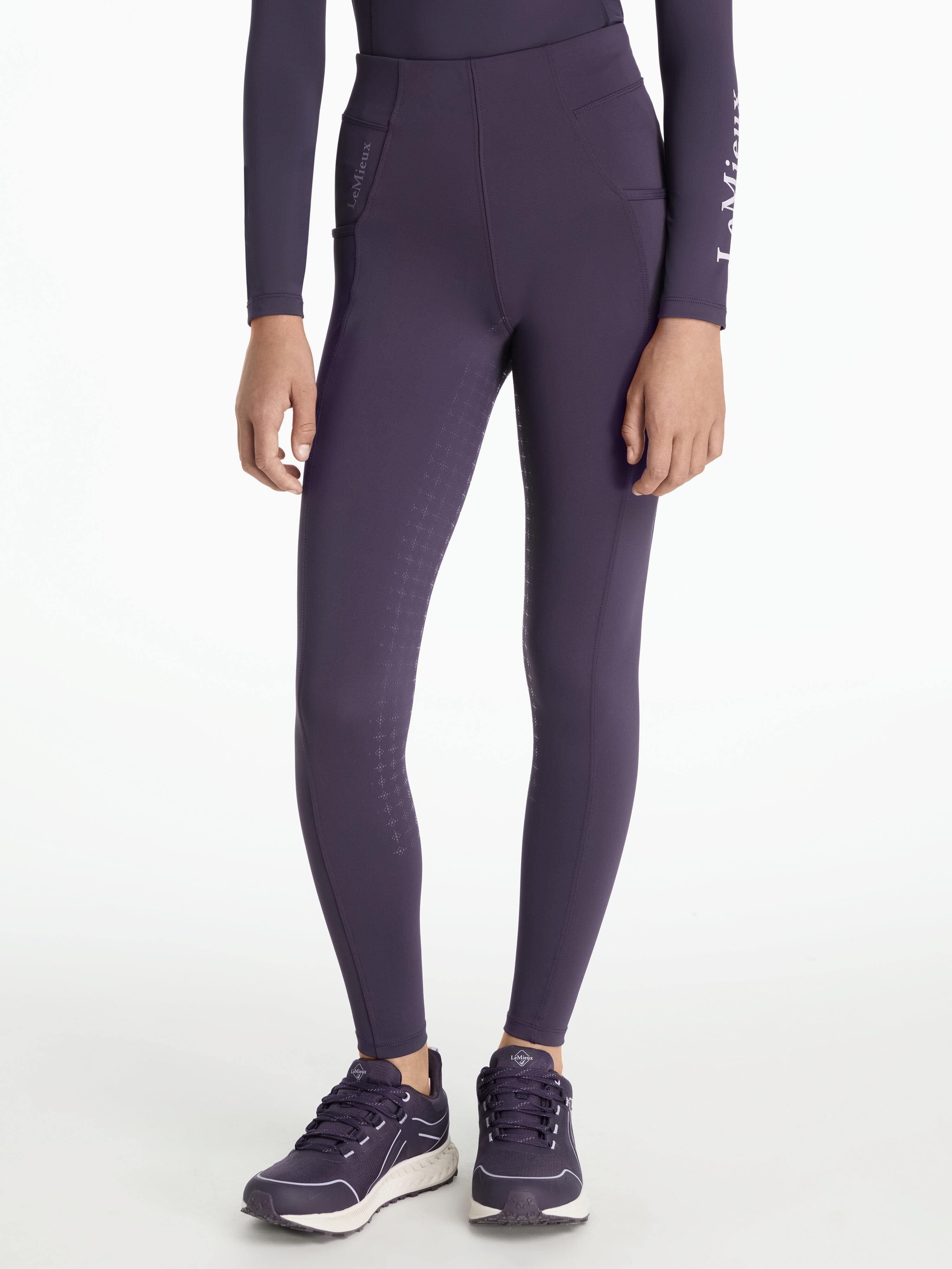 Front view of a model wearing the purple Young Rider Orla Pull On Tight on a white background