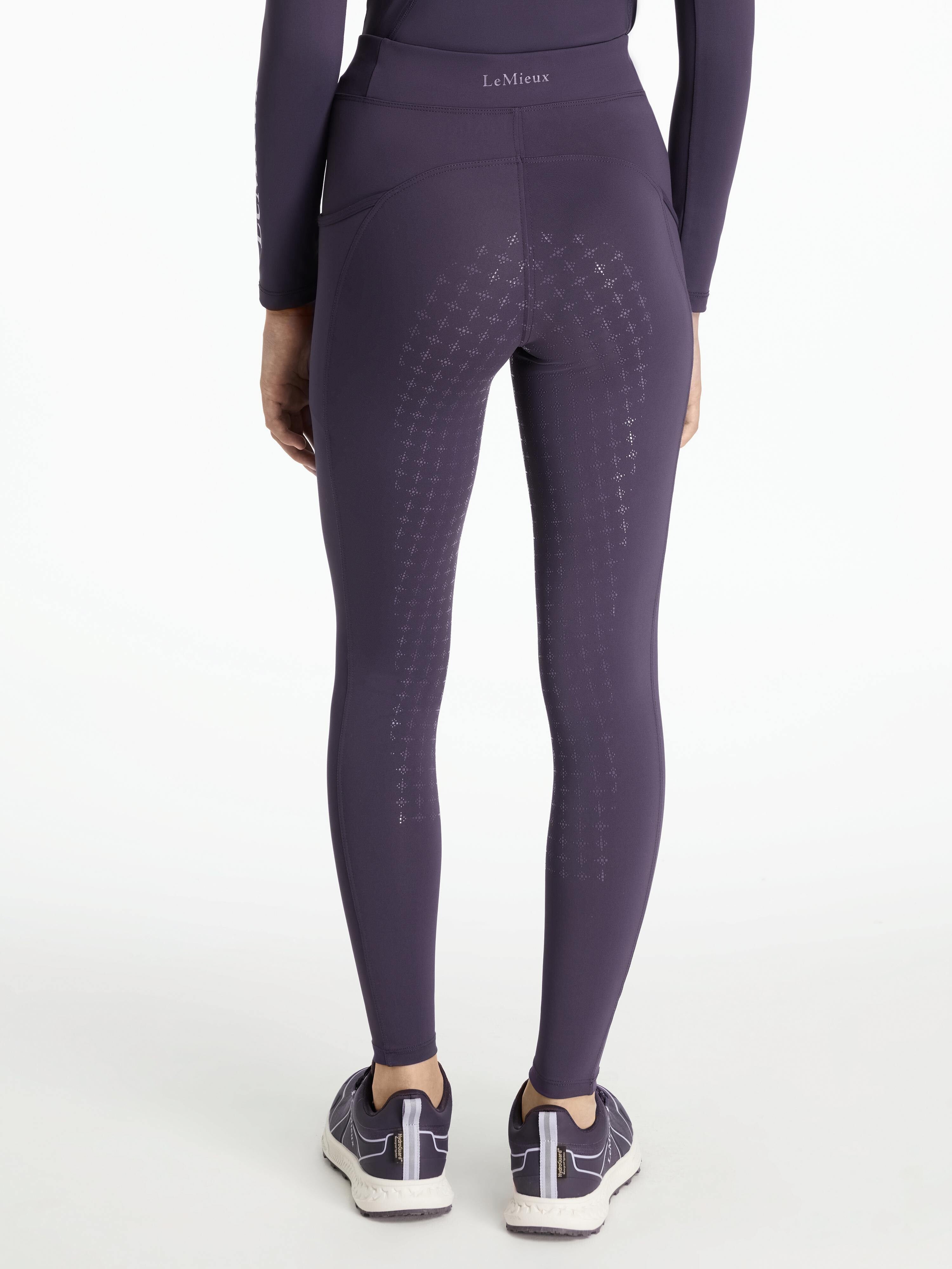 Back view of a model wearing the purple Lemieux Young Rider Orla Pull On Tight on a white background