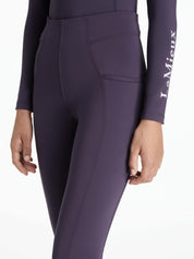 Angled front view of a model wearing the purple Lemieux Young Rider Orla Pull On Tight on a white background