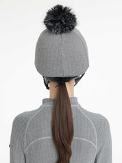 Back view of a female model wearing the Herringbone LeMieux Aspen Hat Silk over a helmet on a plain background