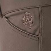 Closeup view of the Dark Brown Equinavia Maud Tech Full Seat Breeches showing an embroidered Equinavia logo near the pocket area