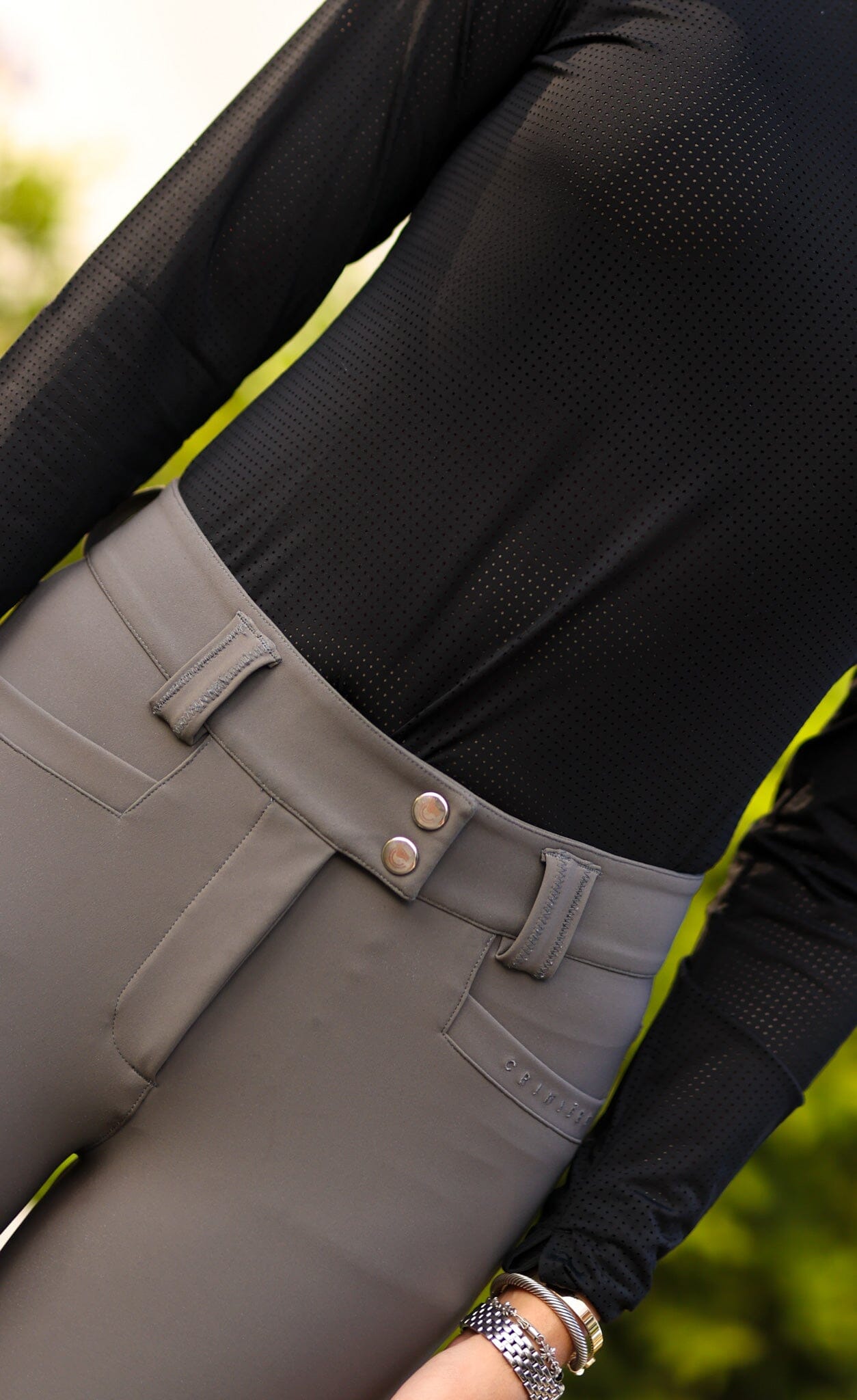 Close-up front view of a female model wearing the Perfect Gray Criniere Juliette High Compression Half Seat Breeches