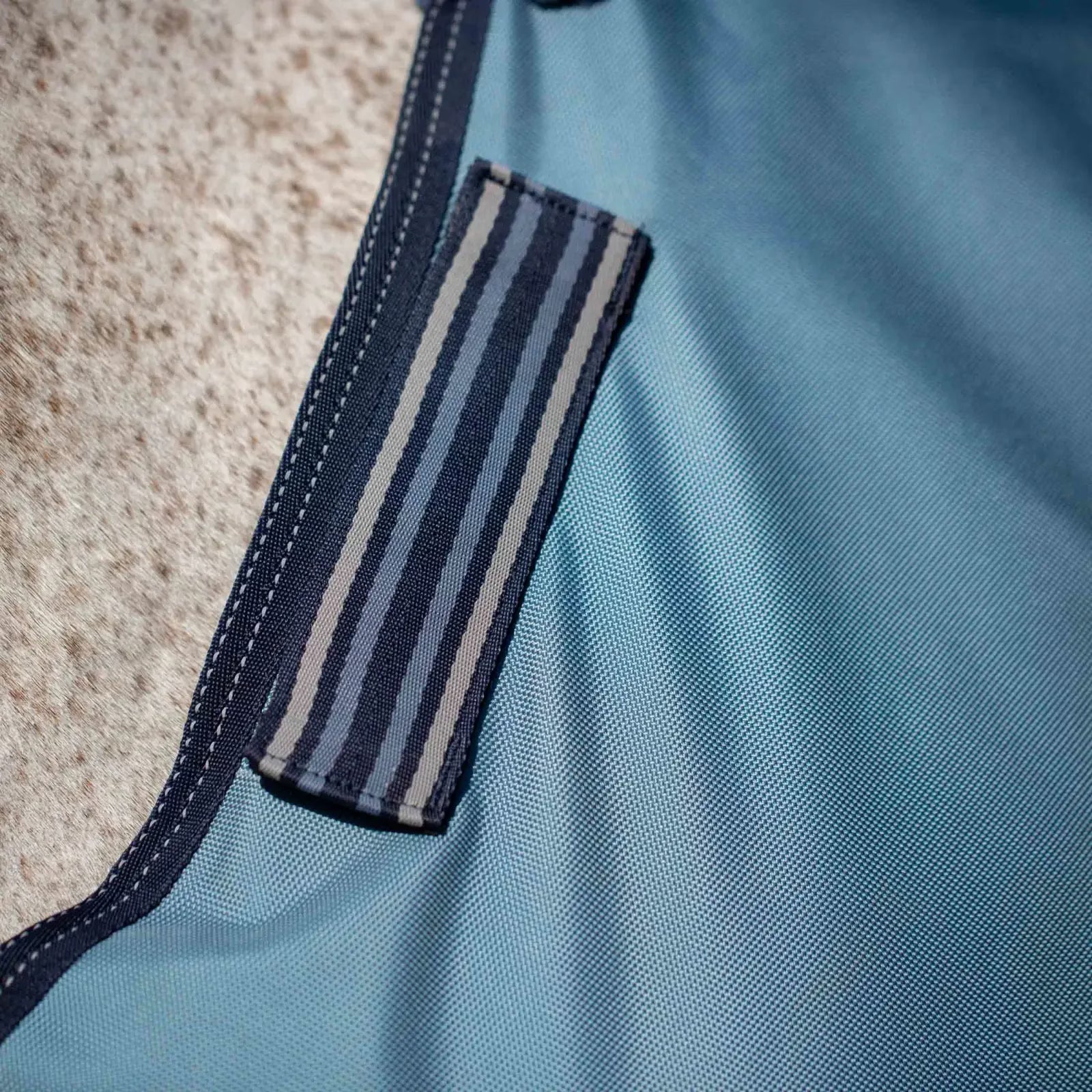 Close-up view of the Equinavia Thunder 360 0g Detachable Neck Turnout Sheet in blue