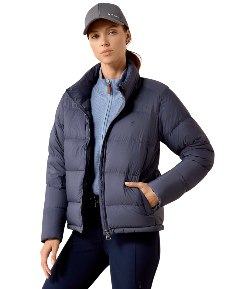 Front view of a female model wearing the Odyssey Grey Ariat Ultrapuff Down Jacket on a white background