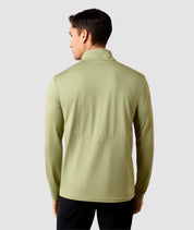 Back view of a model wearing the Oil Green Ariat Men's LunaVeil 1/4 Zip Baselayer on a plain background