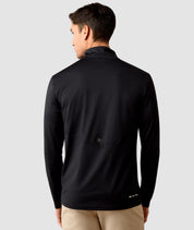 Back view of a model wearing the Black Ariat Men's LunaVeil 1/4 Zip Baselayer on a plain background