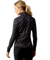 Back view of a female model wearing the Black French Link Ariat Lunaveil 1/2 Zip Baselayer on a white background