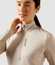 Front view of a female model wearing the Chateau Gray Ariat Lunaveil 1/2 Zip Baselayer on a plain background showing the neck and shoulder area