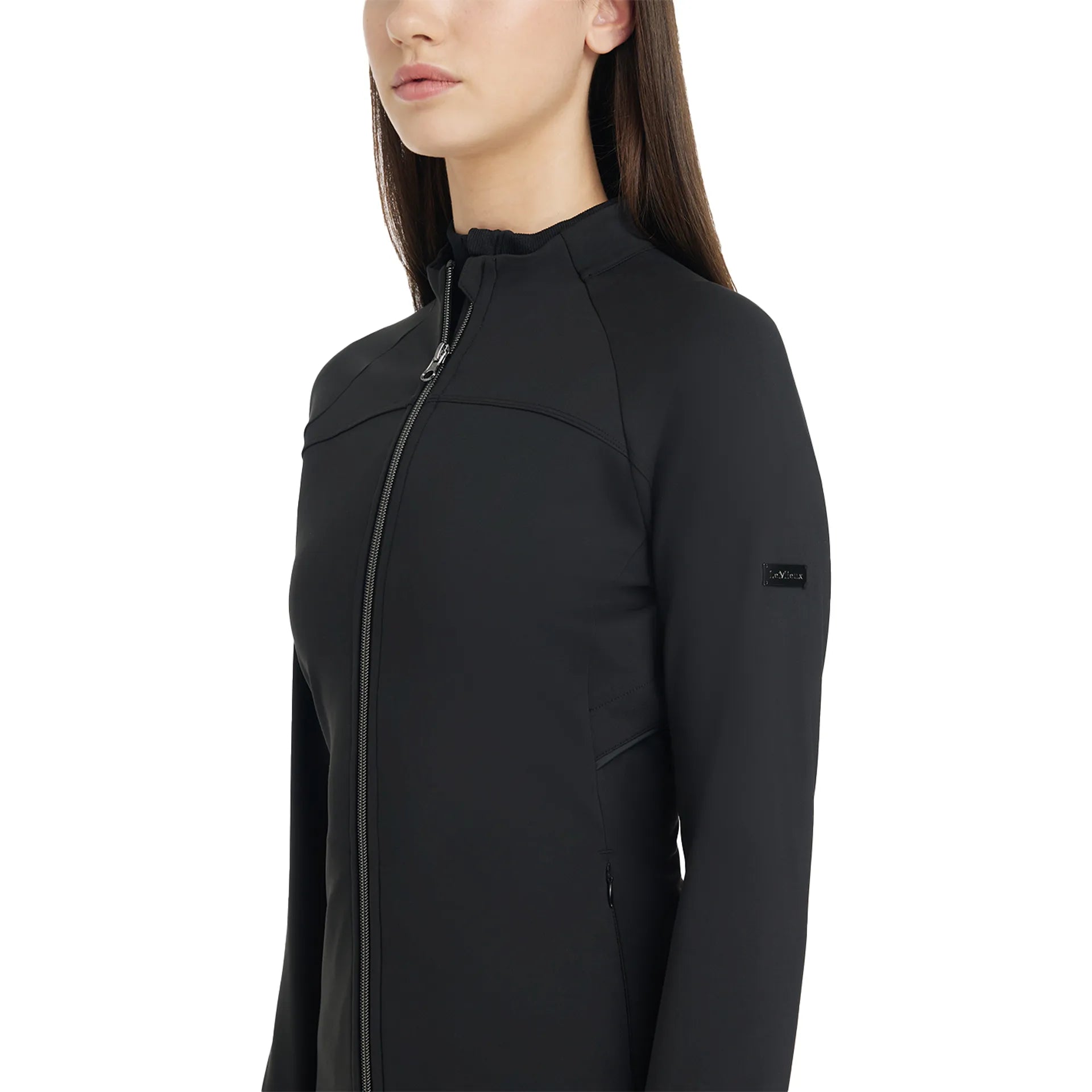 Side view of a female model wearing the Black LeMieux Aspen Brushed Zip Jacket on a plain background