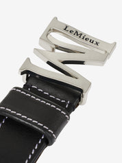 Close-up view of the buckle on the Black LeMieux Monogram Belt on a plain background