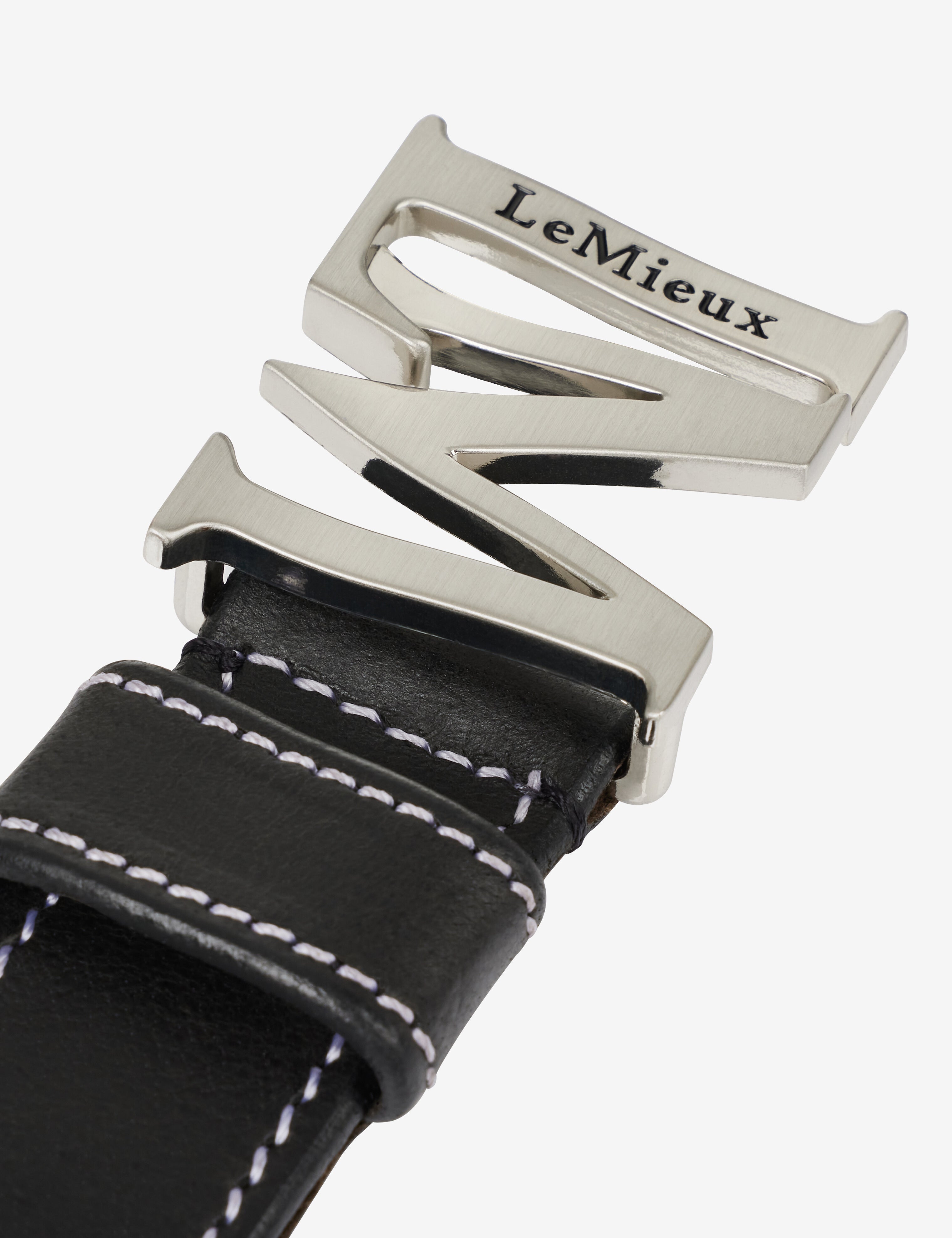 Close-up view of the buckle on the Black LeMieux Monogram Belt on a plain background
