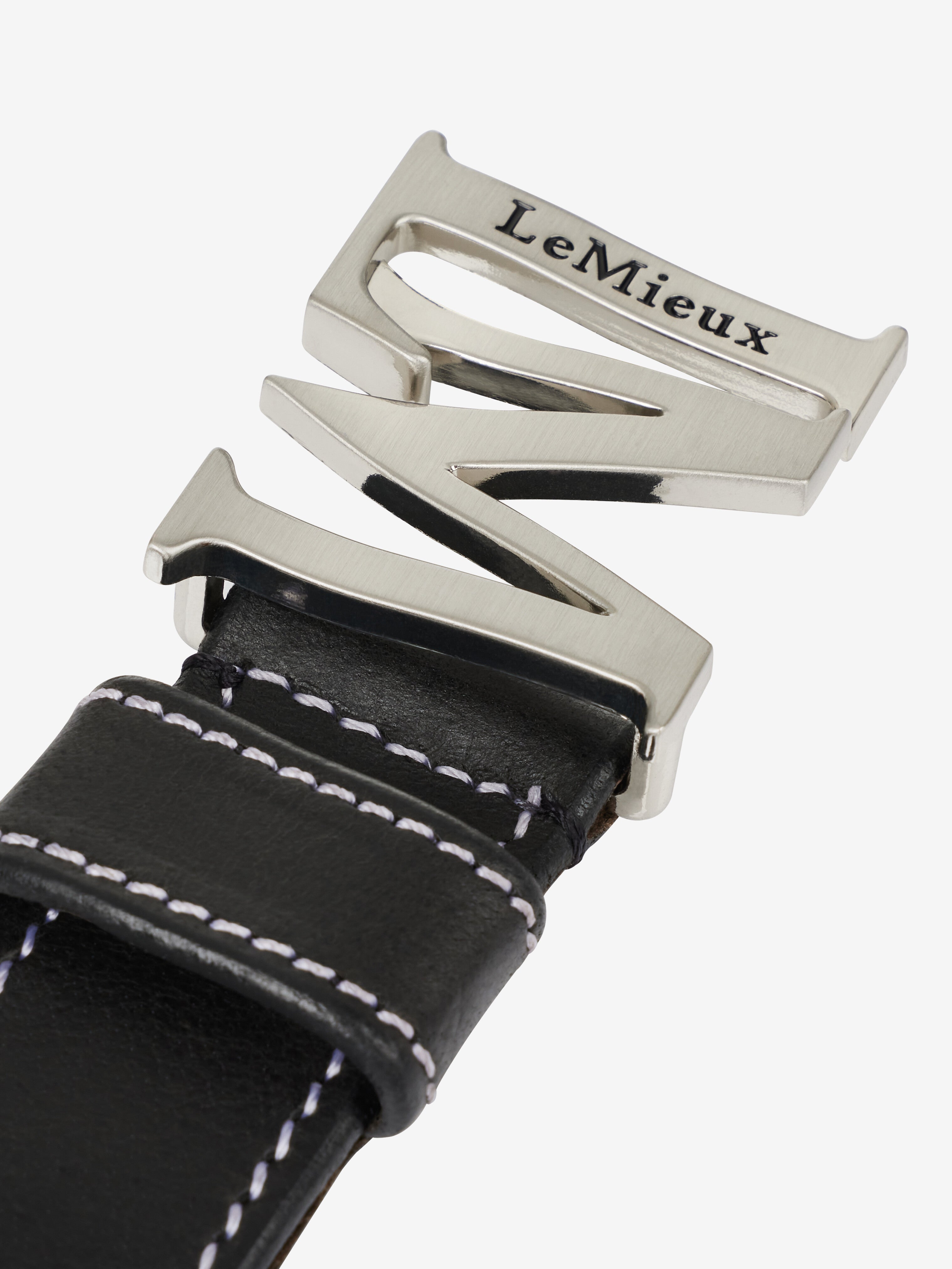 Close-up view of the buckle on the Black LeMieux Monogram Belt on a plain background