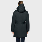 Back view of a female model wearing the Moonless Night Samshield Melyne Puffer Jacket on a plain background