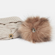 View of the removable pom on the Atmosphere Horze Anni Knitted Hat on a white background