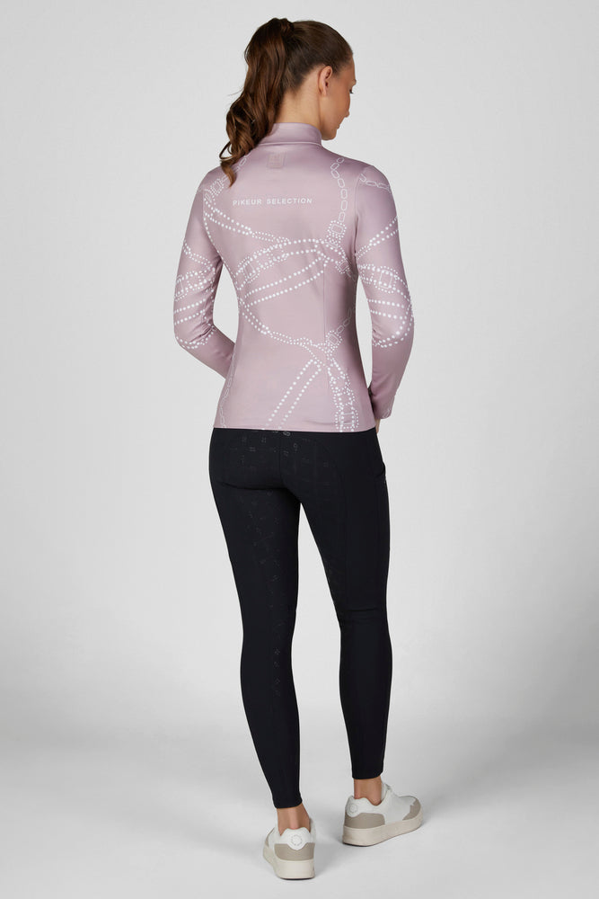 Full body back view of a female model wearing the Ash Mauve Pikeur Zip Print Shirt with black breeches on a plain background
