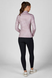 Full body back view of a female model wearing the Ash Mauve Pikeur Zip Print Shirt with black breeches on a plain background