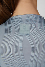 Close-up back view of a female model wearing the Dusty Blue Pikeur Long Sleeve Waveline Shirt