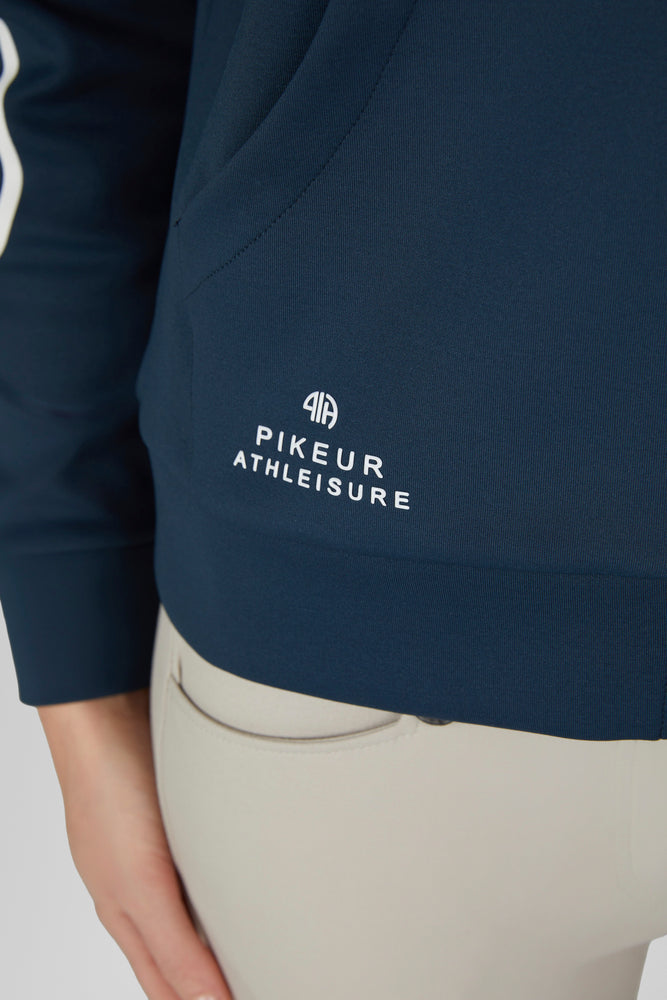 Close up view of the Pikeur logo near the waist hem of the Pine Green Pikeur Athleisure Zip Hoody