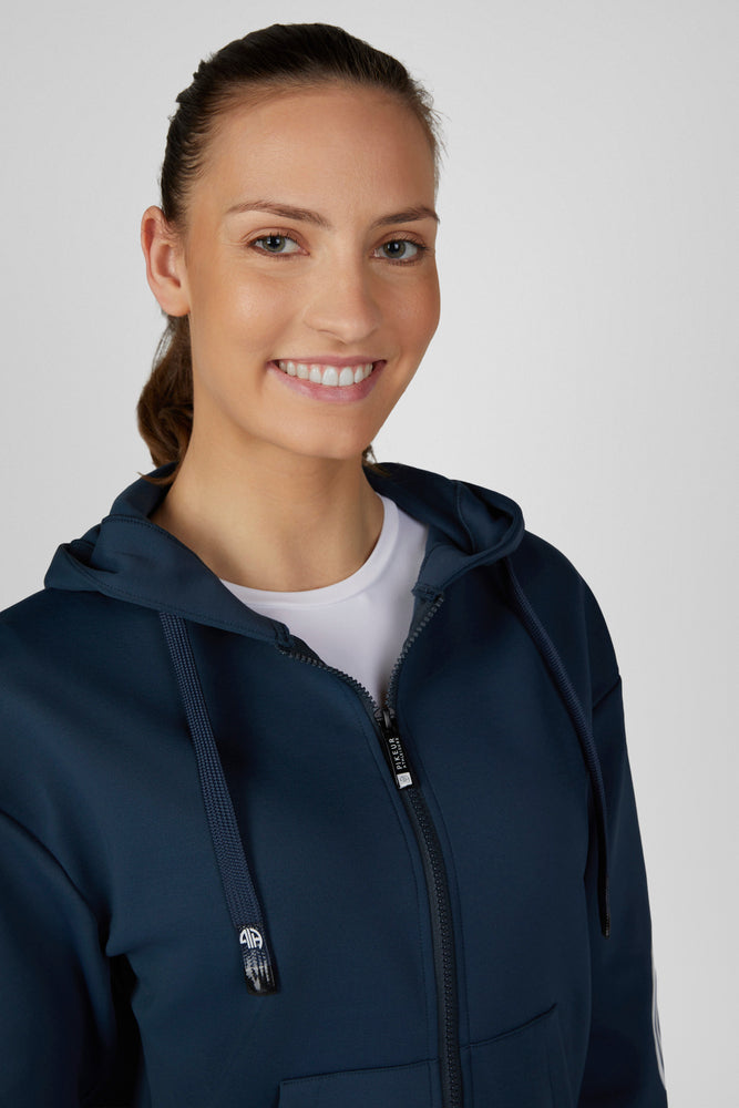 Close-up front view of a female model wearing the Pine Green Pikeur Athleisure Zip Hoody on a plain background