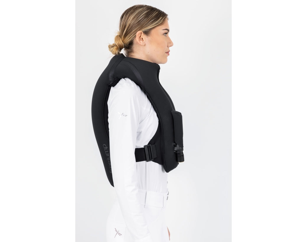 Side view of a female model wearing an inflated Black Freejump Plume Airvest on a plain background
