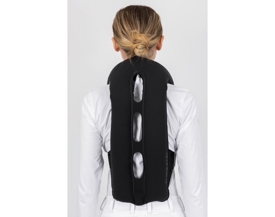Back view of a female model wearing an inflated Freejump Plume Airvest on a plain background