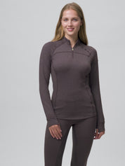 Video of a female model posing while wearing the Cocoa LeMieux Heritage Herringbone Base Layer on a plain background