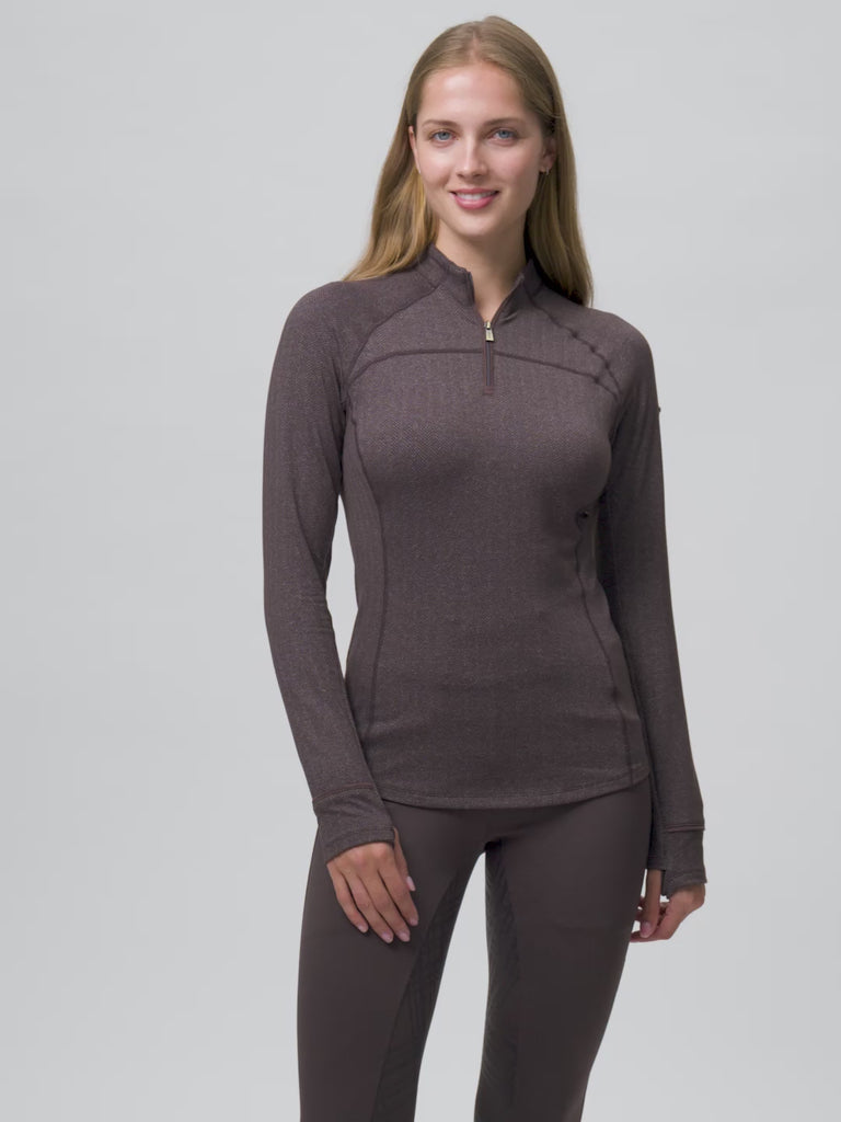 Video of a female model posing while wearing the Cocoa LeMieux Heritage Herringbone Base Layer on a plain background