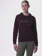 Video of a female model posing while wearing the Damson LeMieux Elspeth Hoodie on a plain background