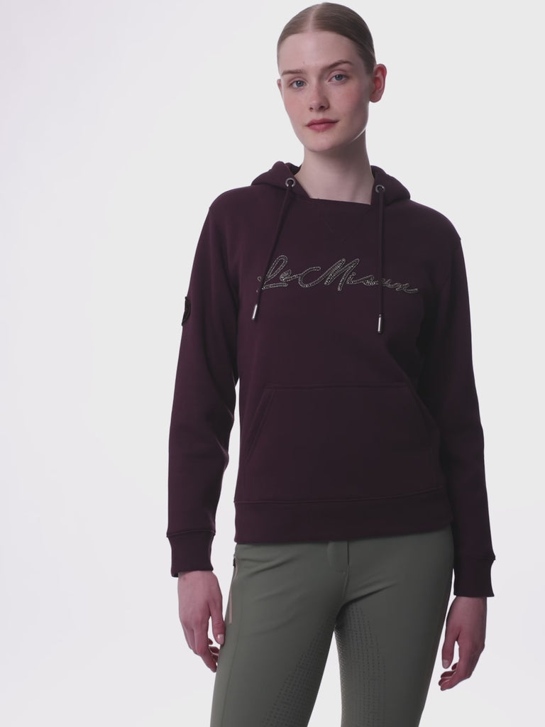 Video of a female model posing while wearing the Damson LeMieux Elspeth Hoodie on a plain background