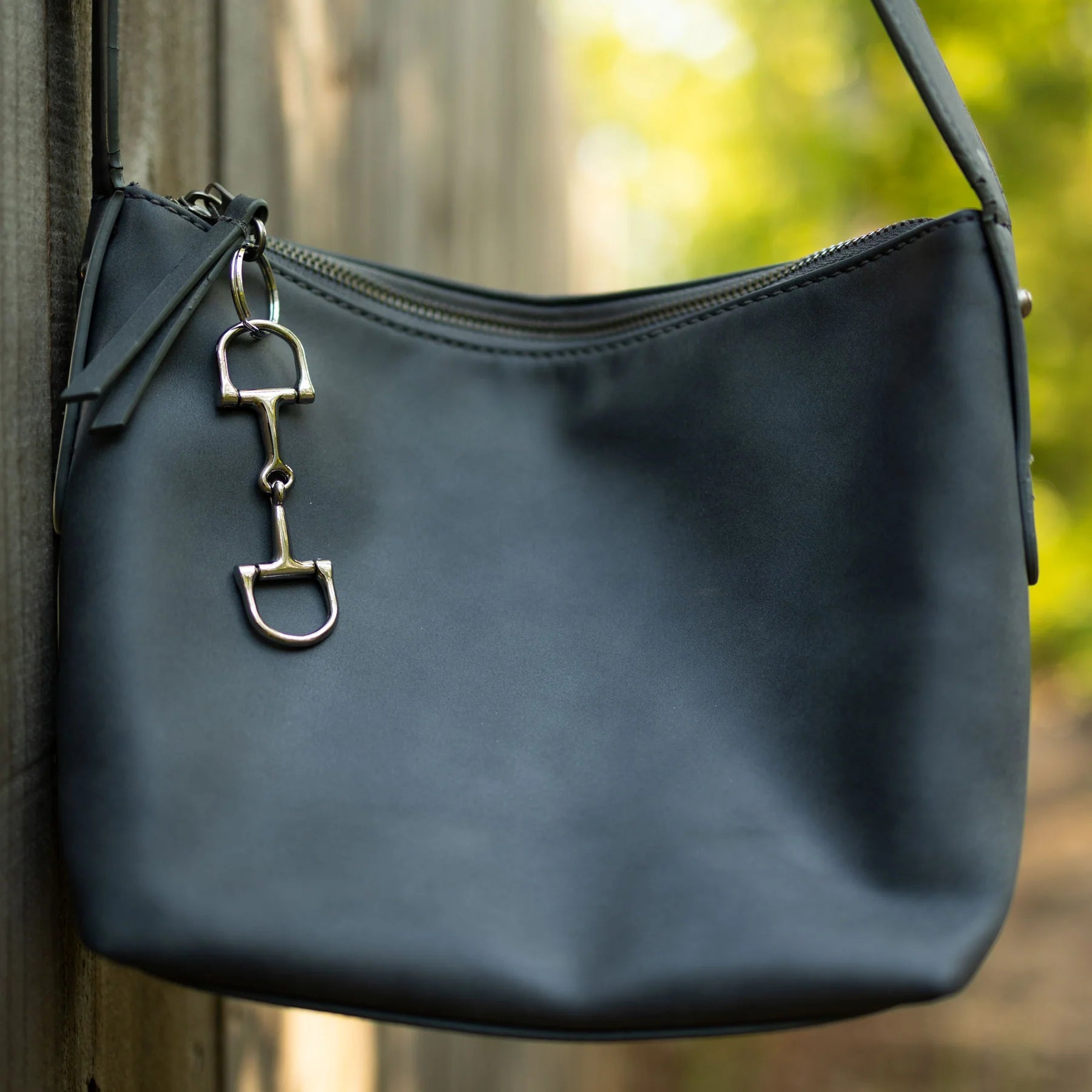 View of the Horze D-Ring Bit Key Chain attached to a purse zipper pull