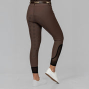 Angled back view of a model wearing the Dark Brown Equinavia Maud Tech Full Seat Breeches on a plain background