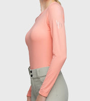 Side view of a model wearing the Kastel Coral Monogram Crewneck Long Sleeve Shirt on a plain background
